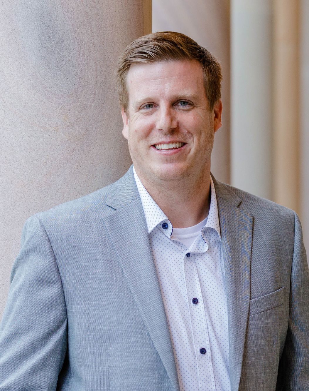Headshot with Ben in grey suit