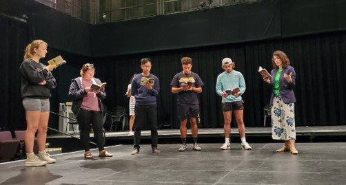 Students performing in a theatre.