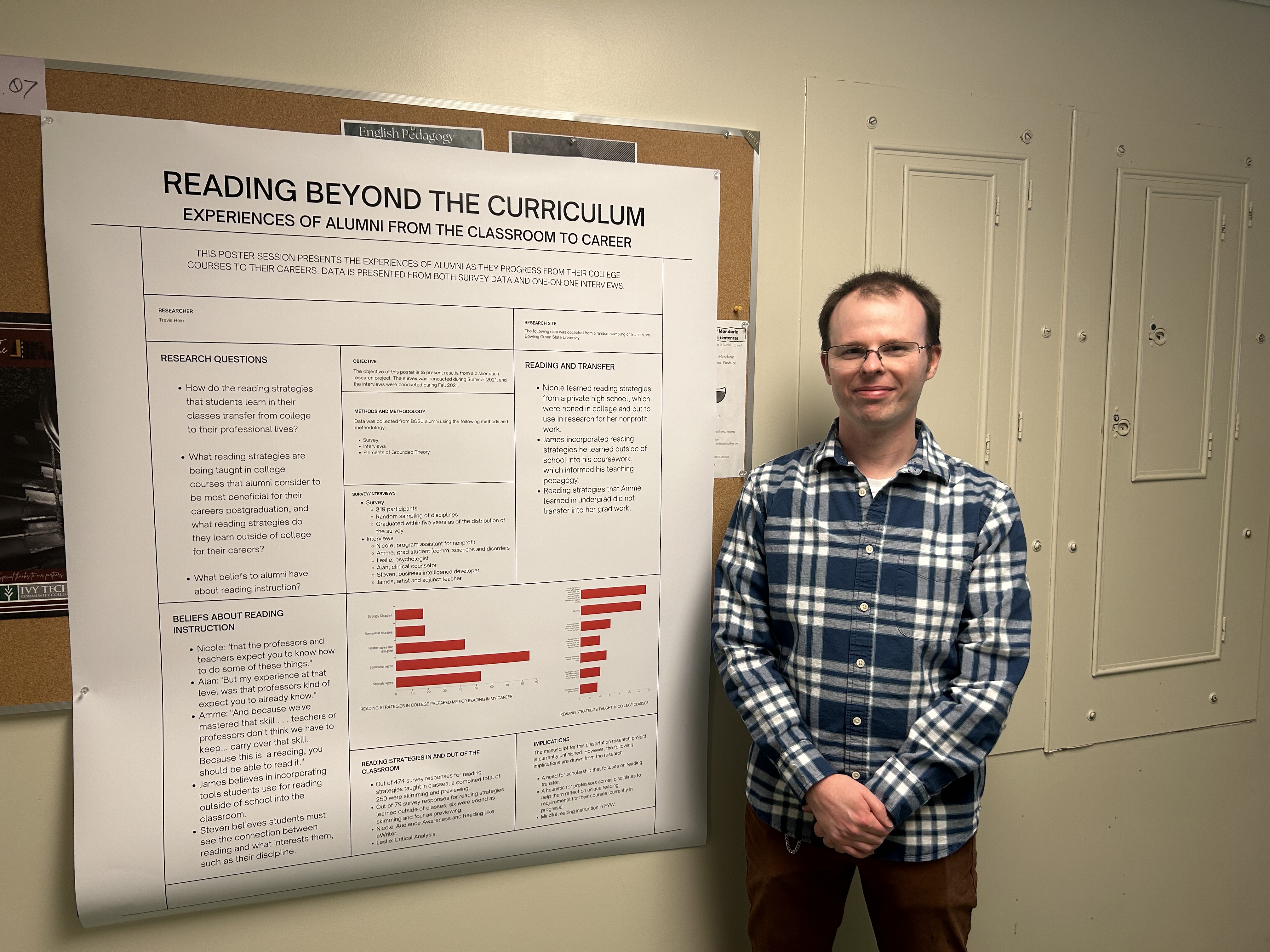Travis stands in front of his research poster.