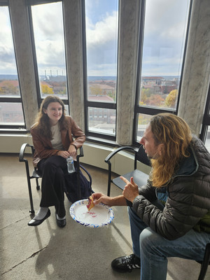 Two individuals having a discussion in a conference room.