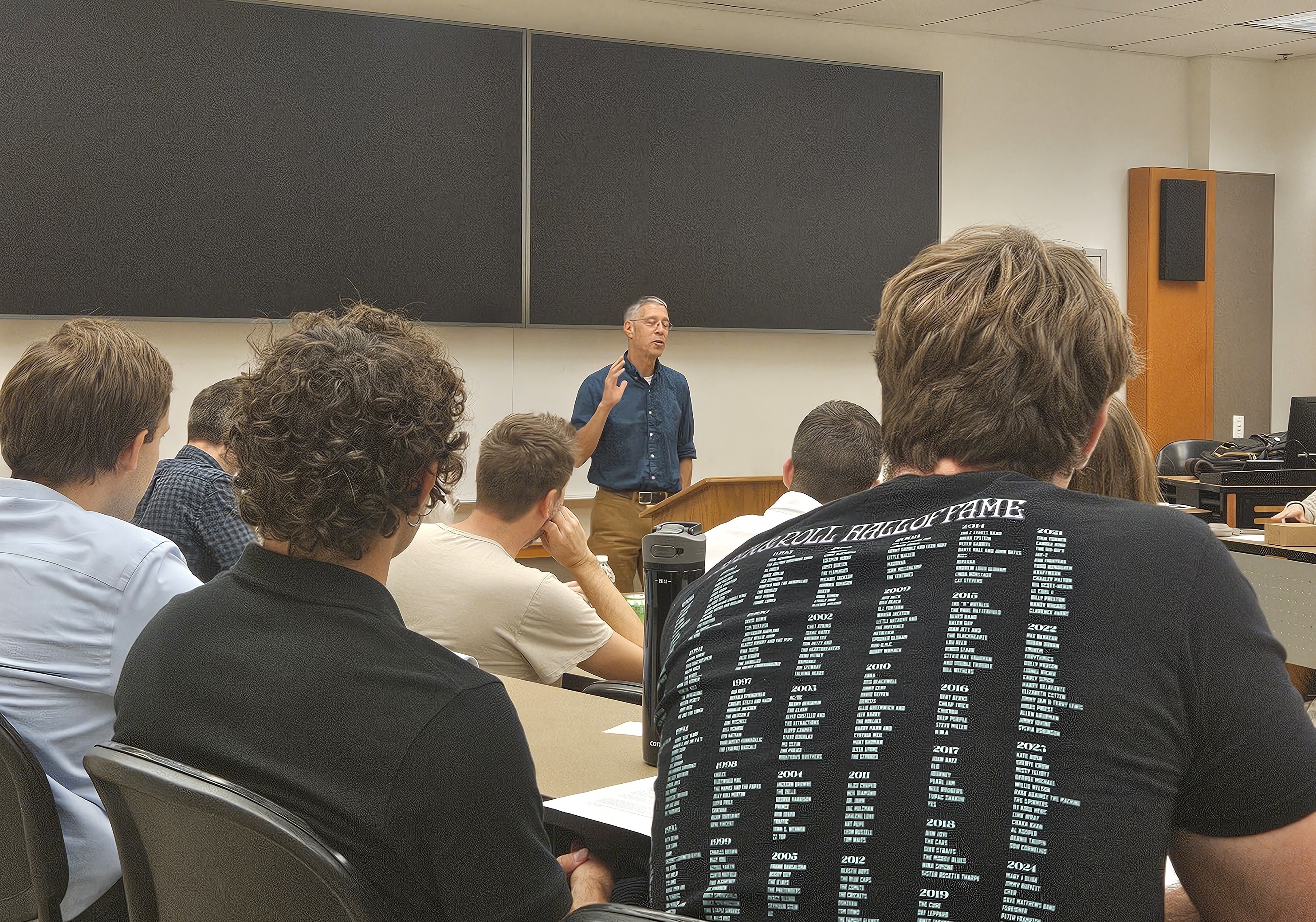 Students listening to a presentation at a conference.