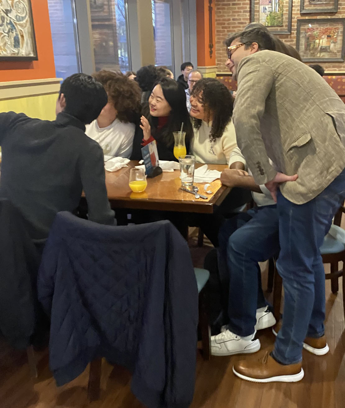 Students and professors sitting around a table