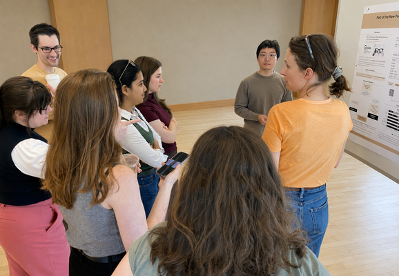 Students and faculty talking at a second-year poster session