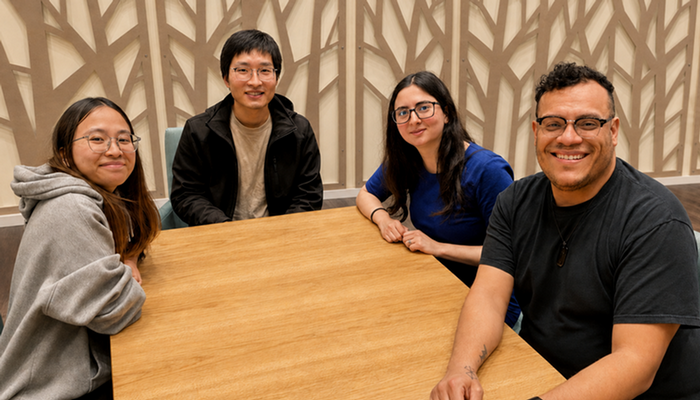 Four graduate students at a department event