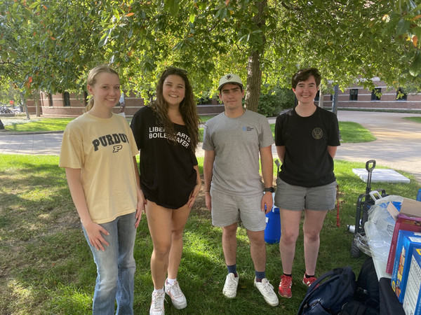 Group of four students standing outside