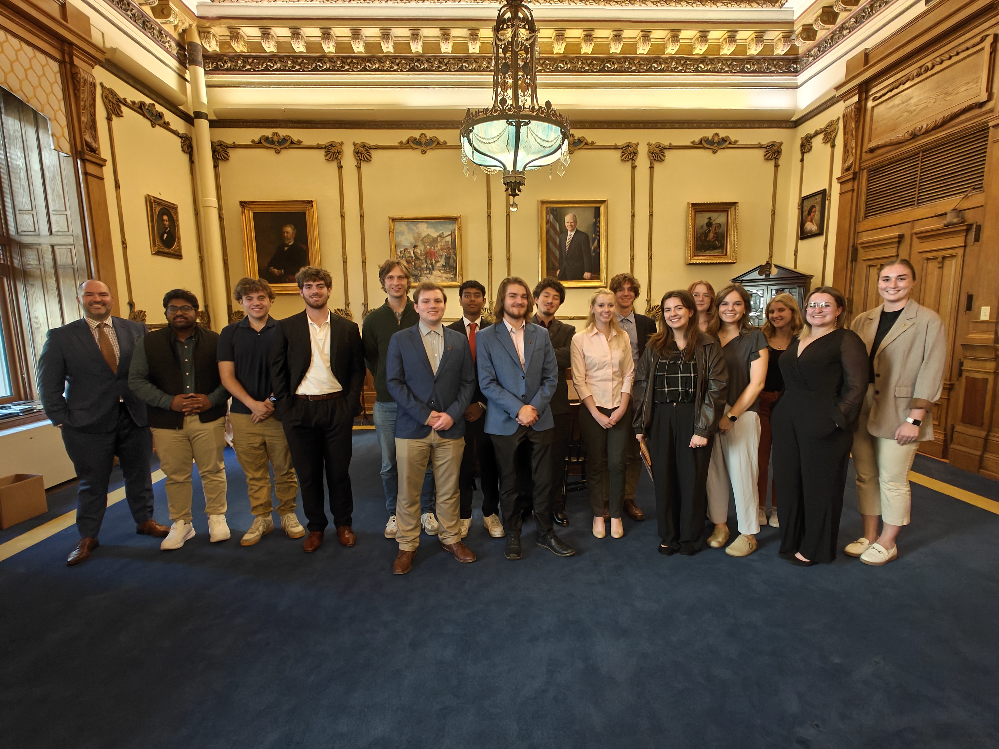 Student group posing with alumni in the Indiana governor's office.
