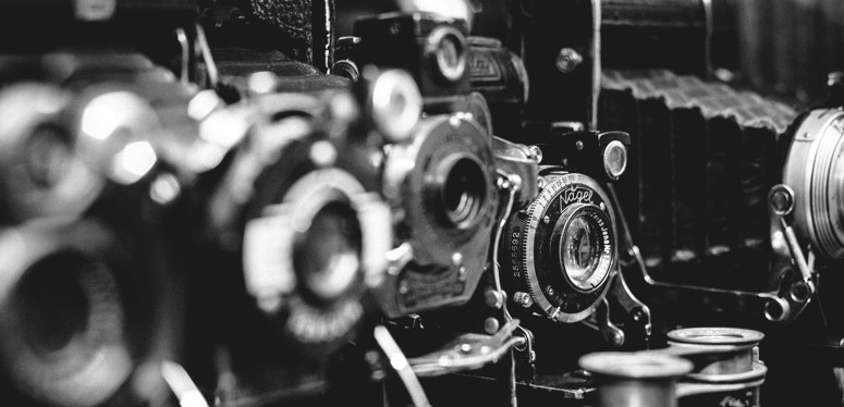 Several old cameras in a row.