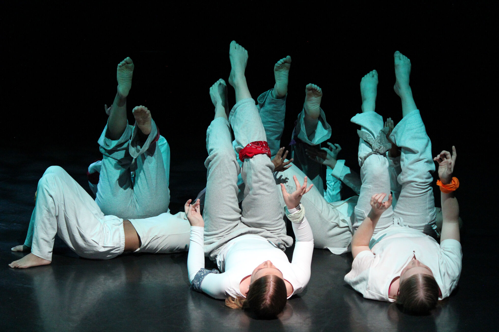 Dancers on the floor sitting in a circle 