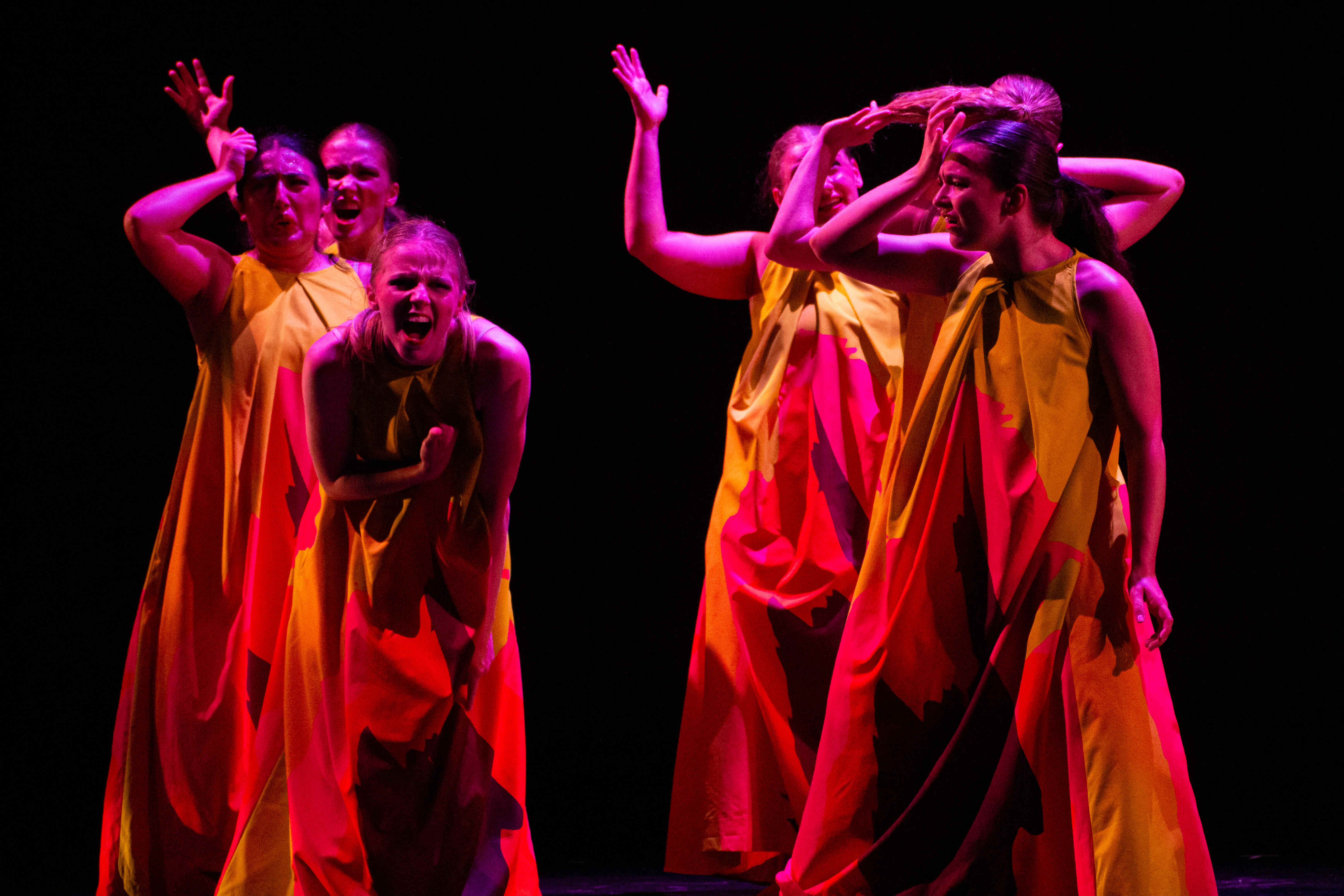 Two dancers on stage on the floor.