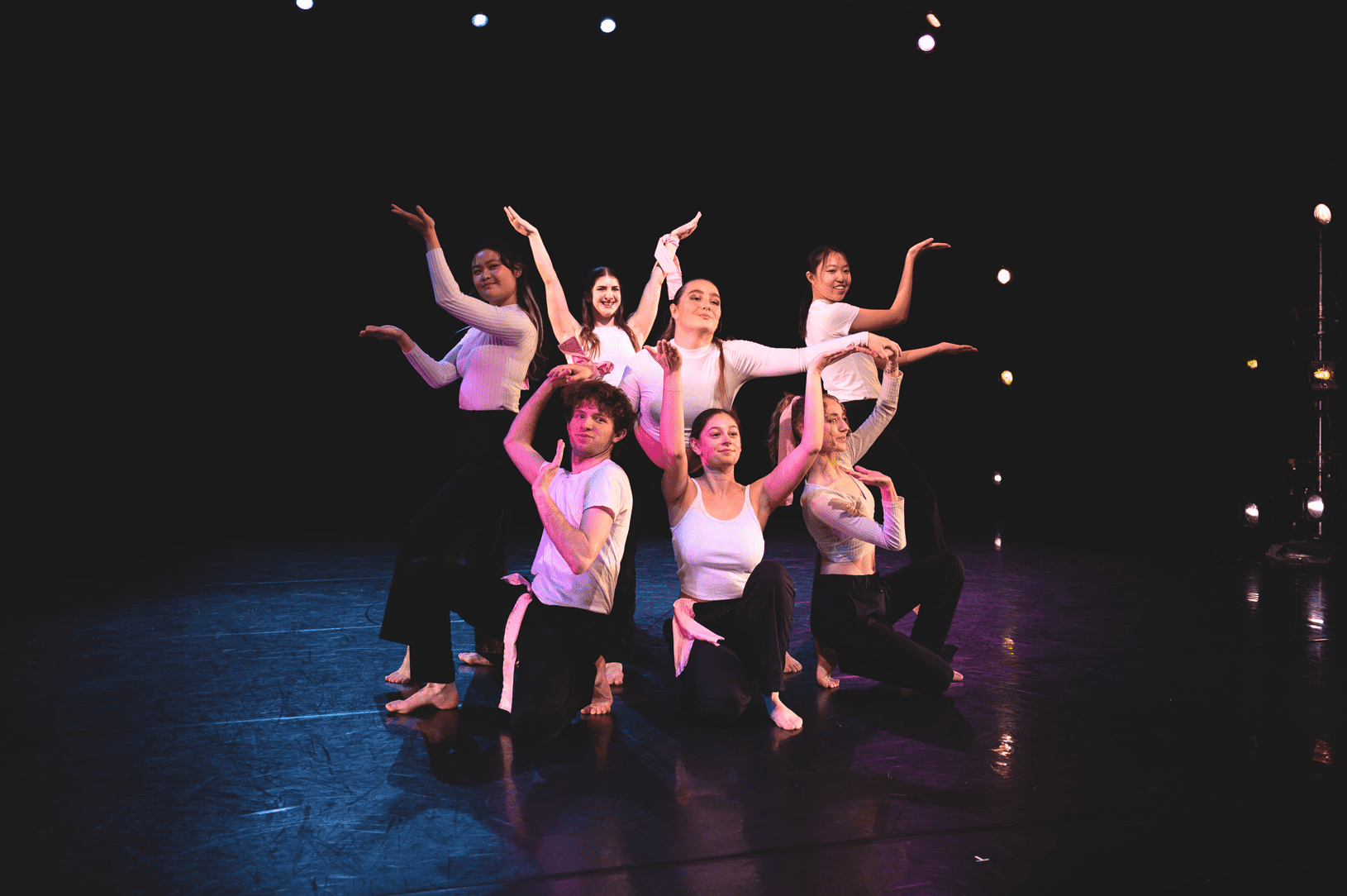 Group of dancers on stage in a pose.