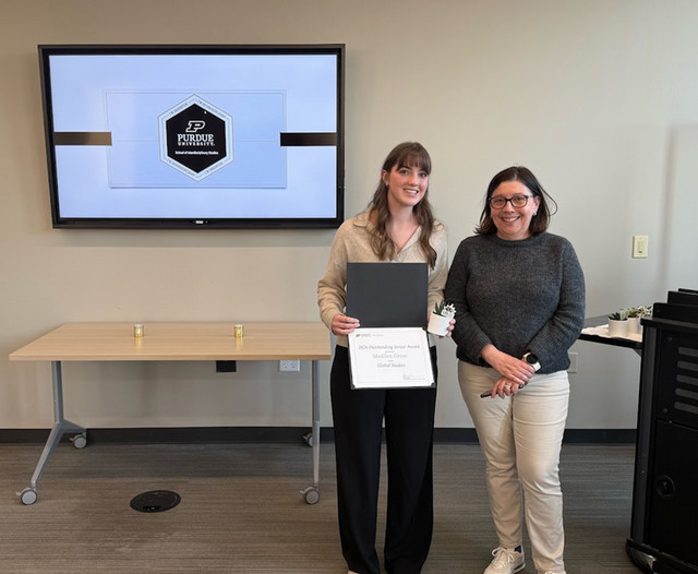 Madeline and Elena standing at award ceremony