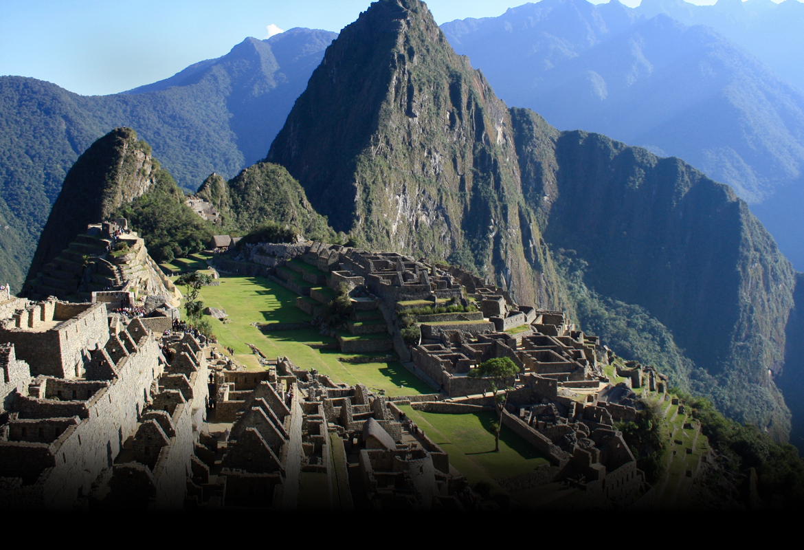 Overhead view of ruins nestled in mountains.