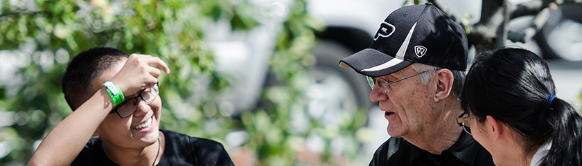 Students talking with a professor.