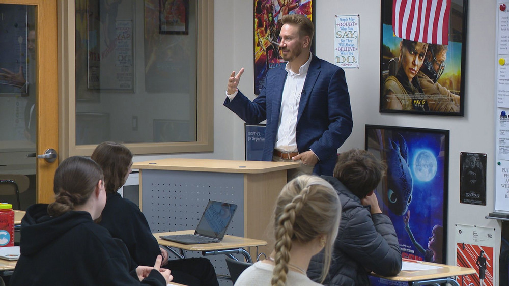 Craig Shaefer standing behind a podium giving a presentation
