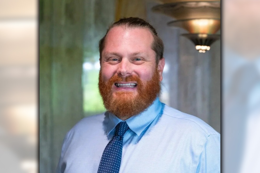 Headshot of Robbee Wedow in a button up and tie.