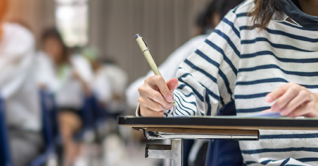 A student taking notes during a class.