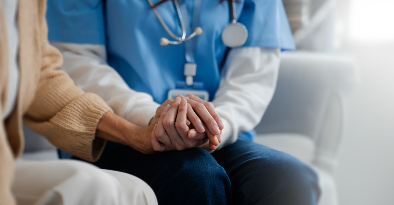 Doctor holding a patient's hand.