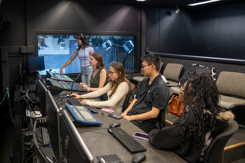 Students working behind the scenes in a studio