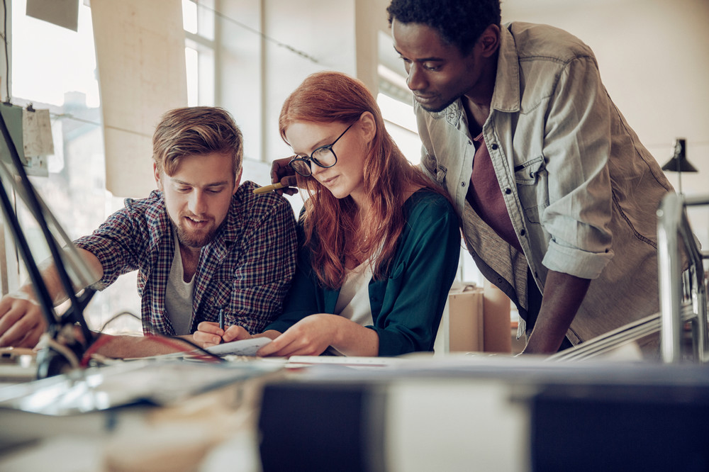 Three students working on a project together