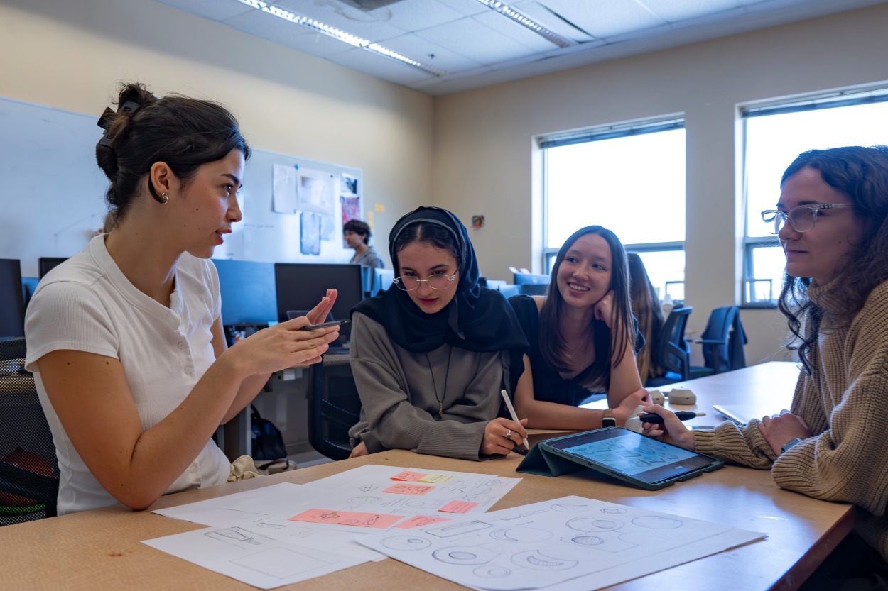 A group of students discussing a project in a classroom.
