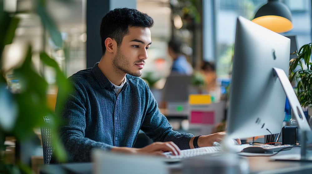 A person sitting at a desk working at their full-time job