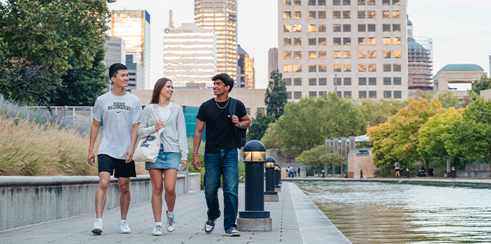 Students walking along a path near some water in Indianapolis