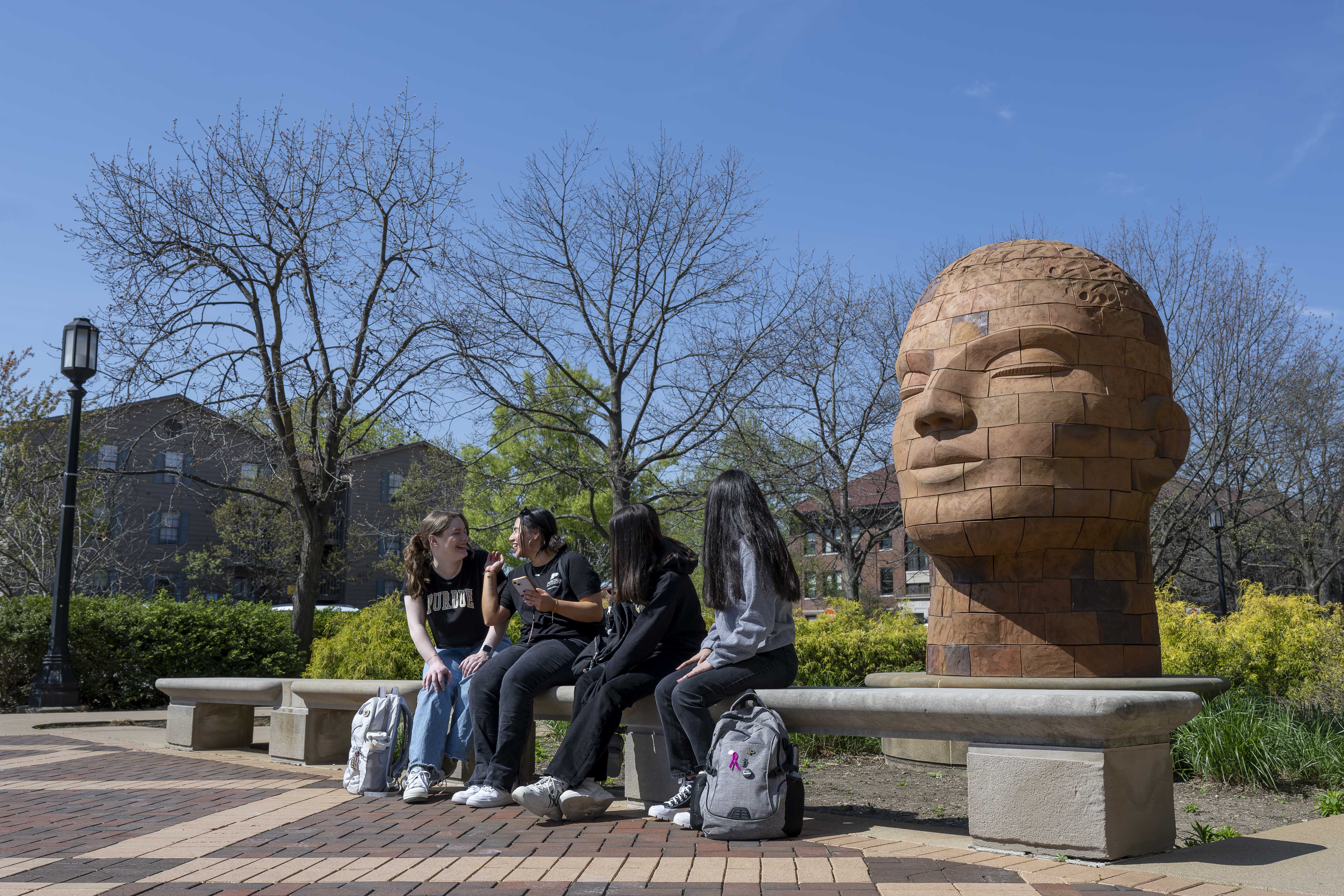 Four students on a set, recording an interview.