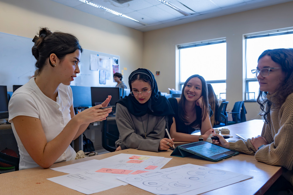Three Purdue University students working on a design project